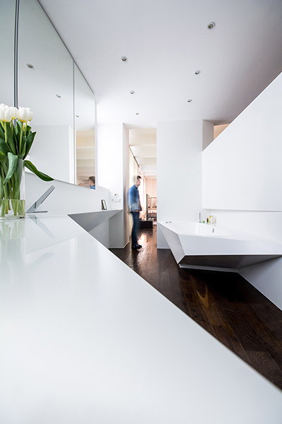 Contemporary bathroom design with geometric bathtub and large sink