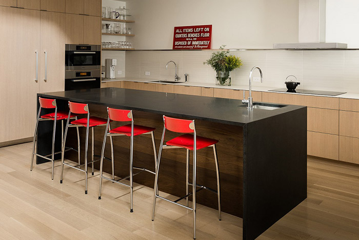 Contemporary kitchen design with modern red chairs