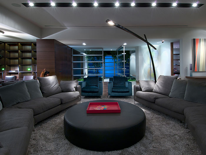 Contemporary living room design with oval coffee table in Californian home by Whipple Russell Architects