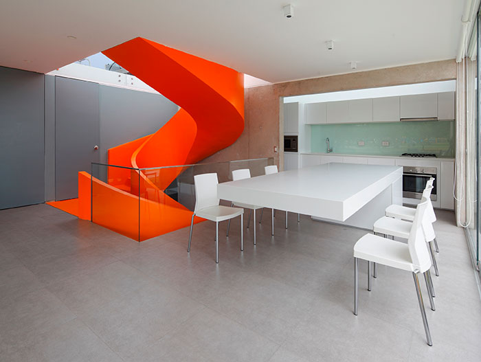 Modern Dining Room With Stunning Orange Staircase