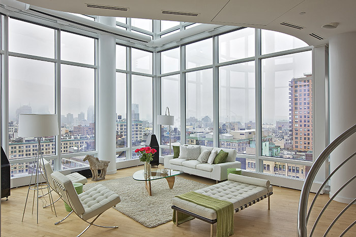 Modern Living Room With Beautiful White Sofa And Chairs And Stunning Views