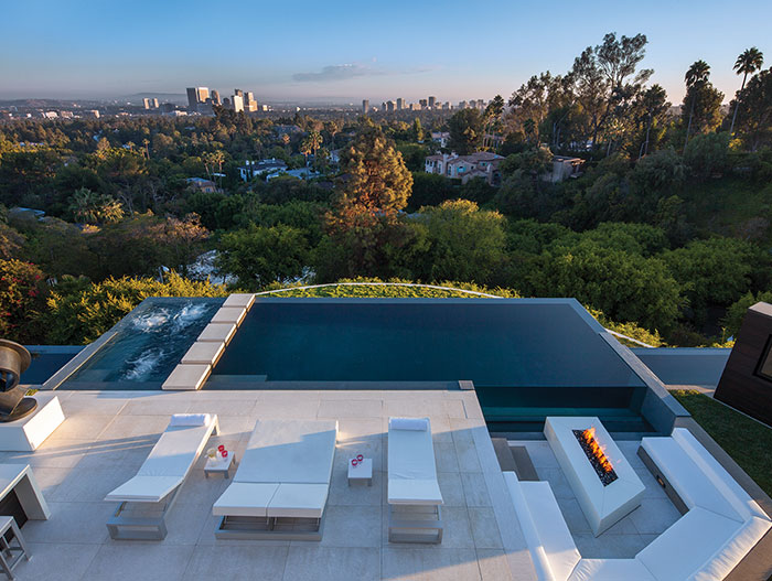 Outdoor entertainment area with zero edge infinity pool and impressive views