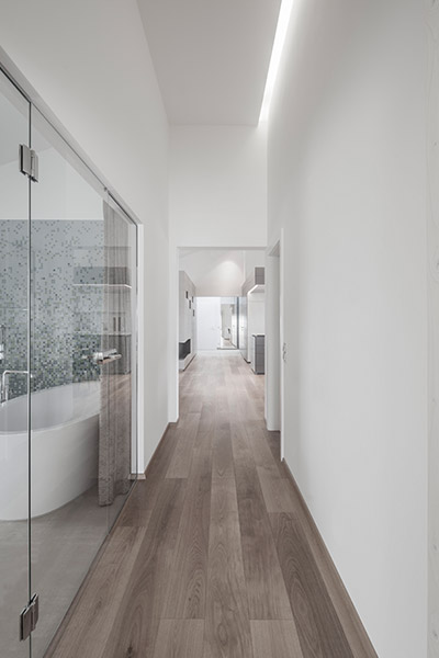 White Hallway Leading To Bathroom