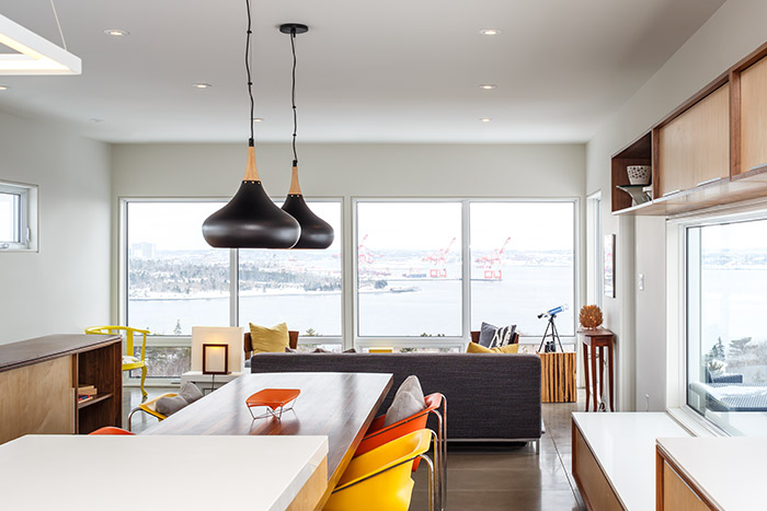 Amazing open-space living and dining area with stunning views in a contemporary three-storey house in Canada by Omar Gandhi Architect