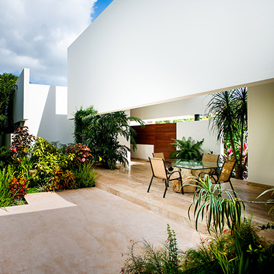 Amazing outdoor and lounge area in award-winning house in Yucatan, Mexico with lush garden and great swing chair