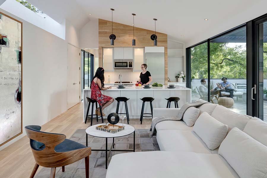 Modern living area in an unconventional Texas home designed to showcase the owners’ car collection