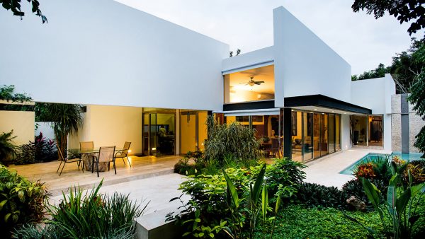 Award-winning house in Mexico lets the owners relax in a swing chair while admiring their lush garden by Seijo Peón Arquitectos y Asociados