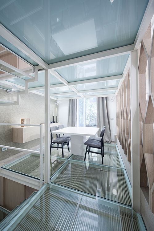 Gorgeous dining area design and glass floor in a beautiful three-level Italian apartment by Archiplan Studio