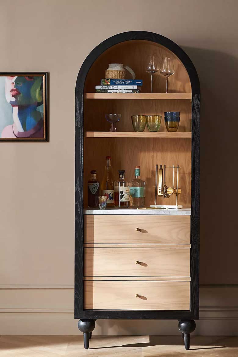 Black arched bookcase with drawers for sale at Anthropologie