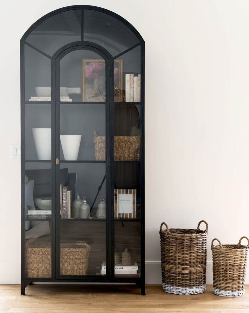 Black arched cabinet with glass doors, perfect for displaying decor items