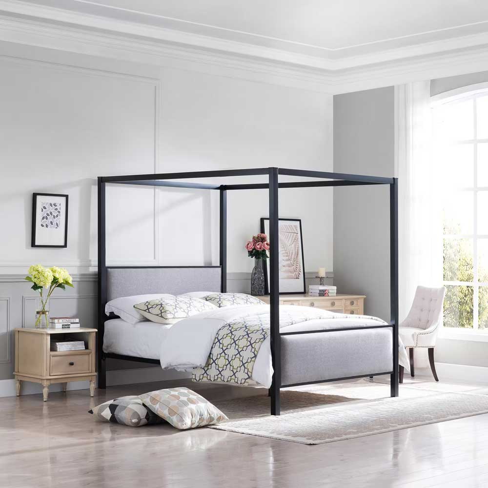 Black canopy bed with gray upholstered headboard and footboard