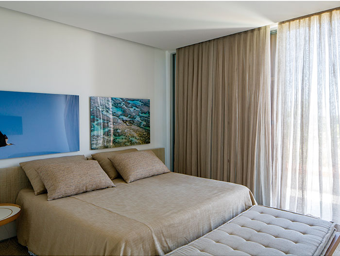 Modern bedroom in breathtaking beach house, perfect for a lavish indoor-outdoor lifestyle