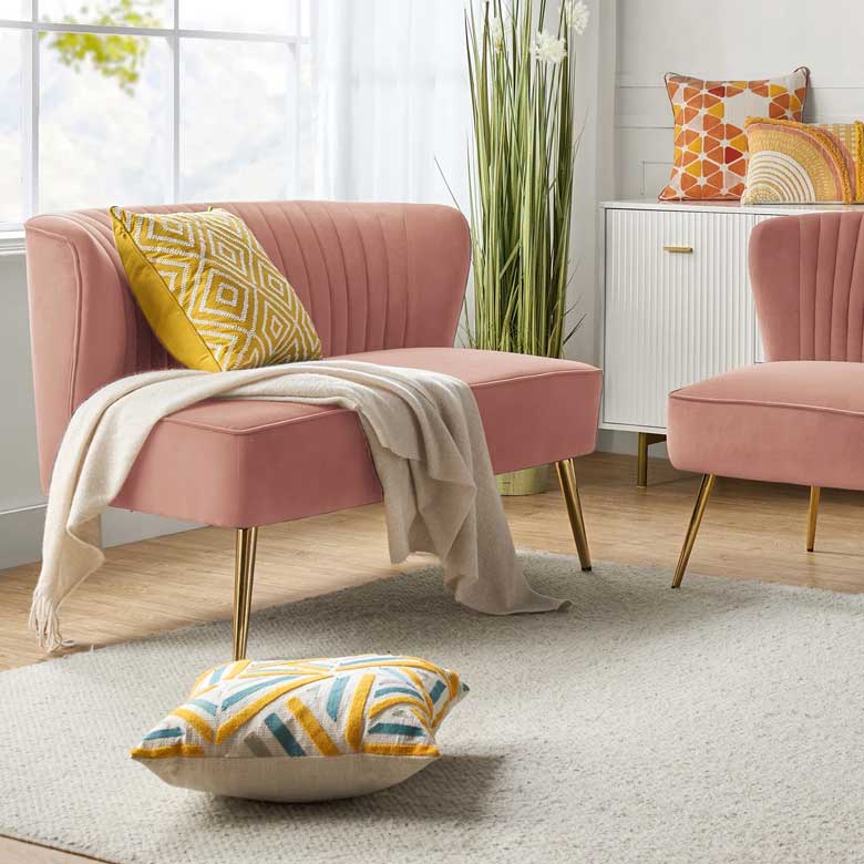 Chic pink velvet loveseat with modern gold legs