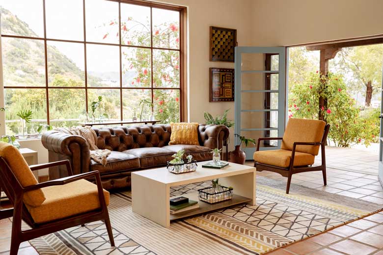 Coffee leather Chesterfield couch with diamond tufted detailing, cozy cushions