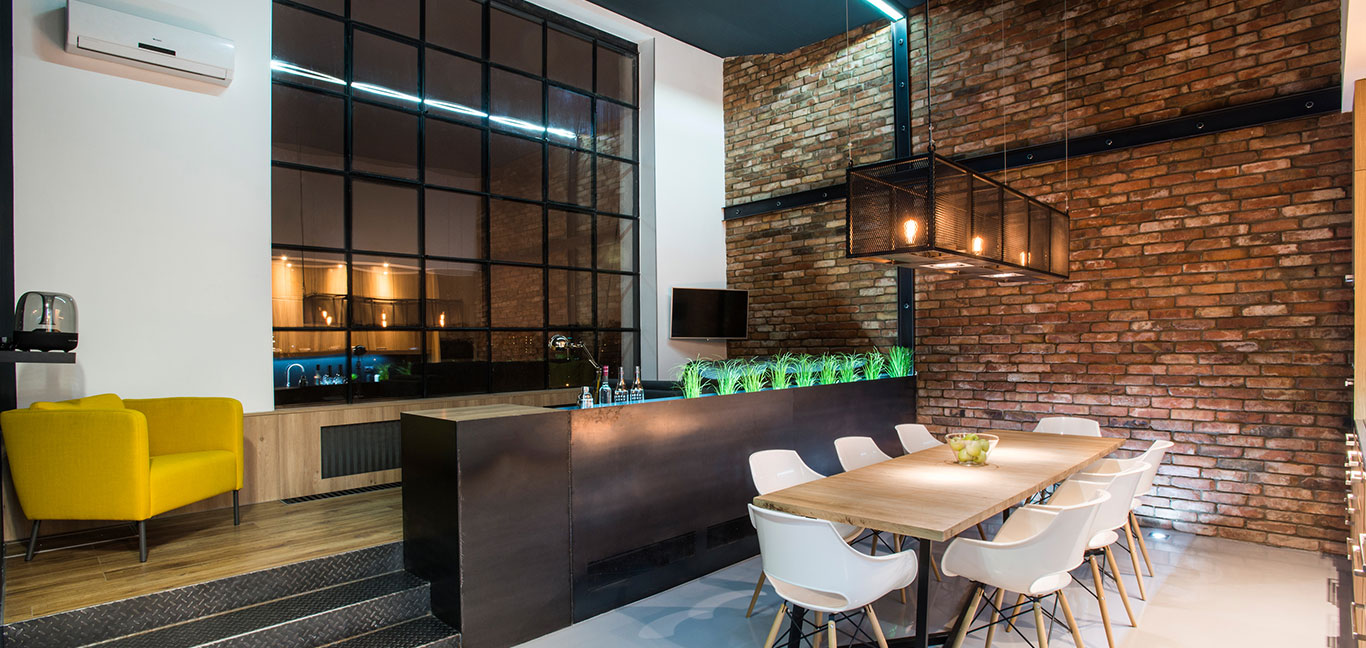 Open plan kitchen, living and dining area of a contemporary two-bedroom apartment in Budapest