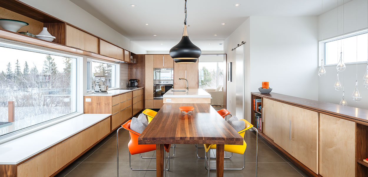 Beautiful open-space kitchen and dining area in a contemporary three-storey house in Canada by Omar Gandhi Architect