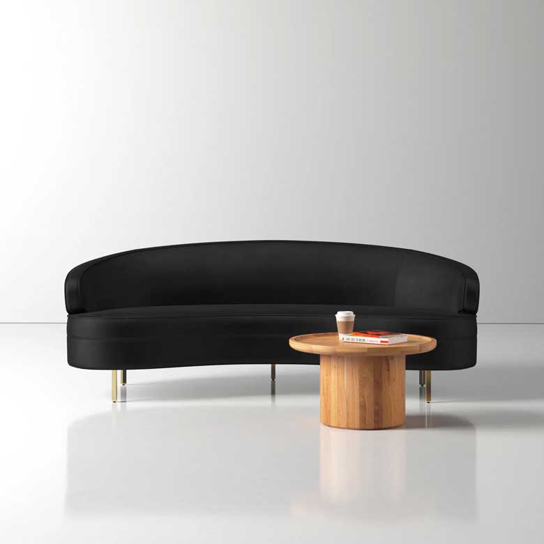 Curved black velvet sofa with gold legs for a contemporary living room or office