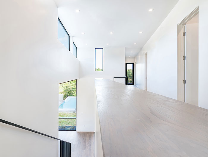 Dazzling Bracketed Space House with modern white interior, located in Austin, Texas - designed by Matt Fajkus Architecture for a young family