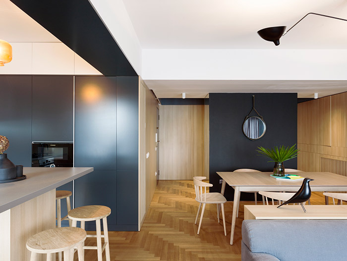 Functional apartment with wooden interior for a small family in Bucharest, Romania
