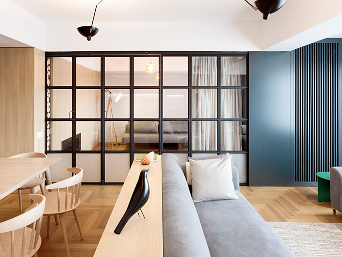 Sliding door in small functional apartment with stylish furniture in Bucharest, Romania