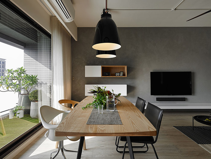 Gorgeous dining area design idea with modern dining table and beautiful white and black chairs in an inviting apartment in Taiwan - by Awork Design Studio