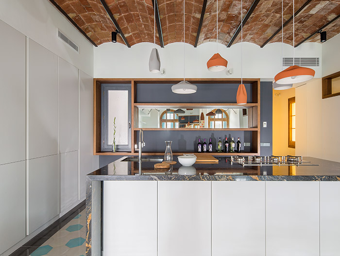 Gorgeous kitchen design idea in a stunning apartment in Barcelona that uses mirrors to amplify space and light