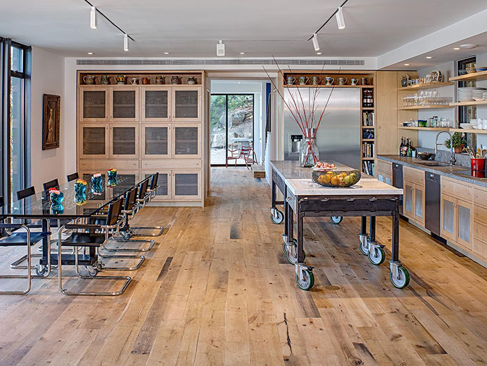 Industrial looking kitchen and dining area in modern house near lake Austin, Texas