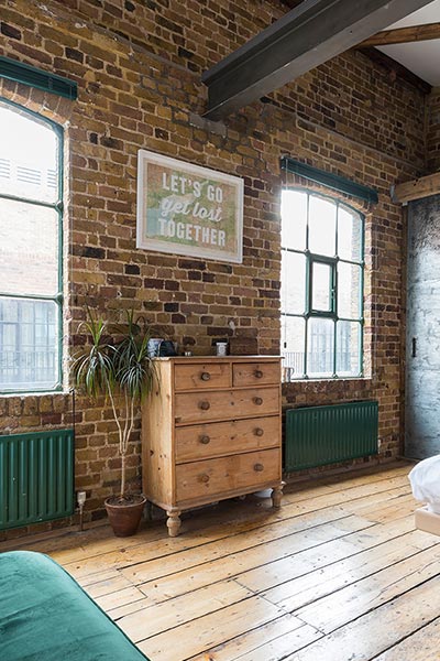 Industrial penthouse in Shoreditch, London features exposed brick walls and copper elements