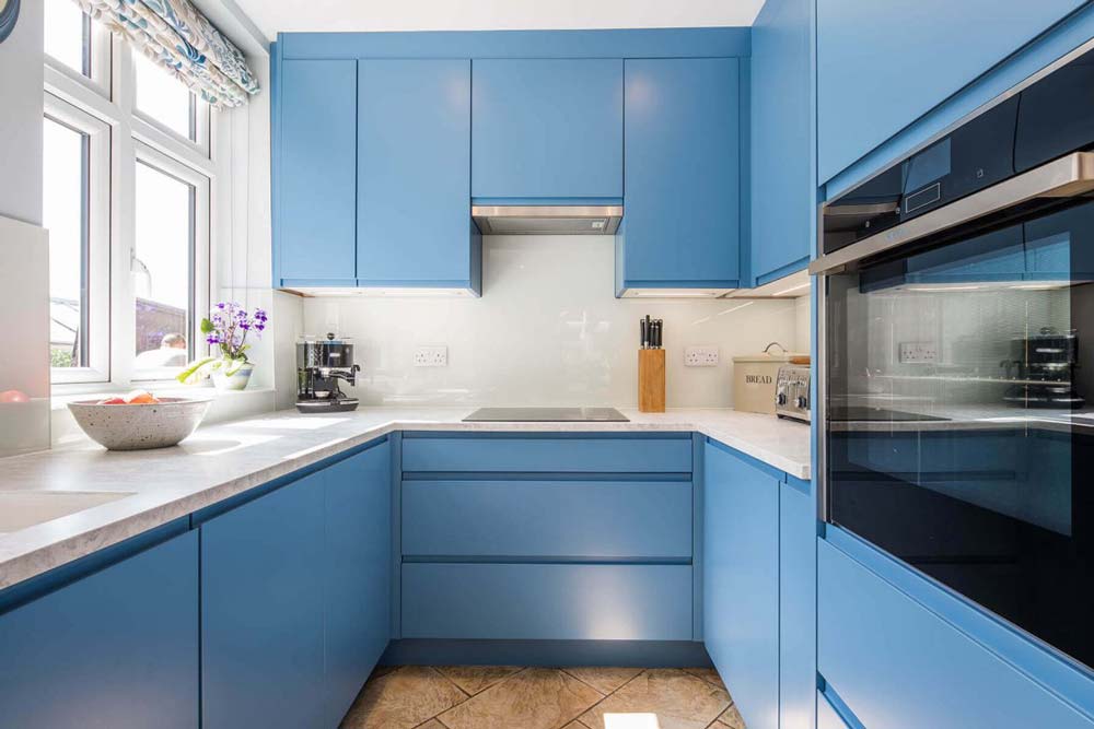 U-shaped kitchen with light blue handleless cabinet doors