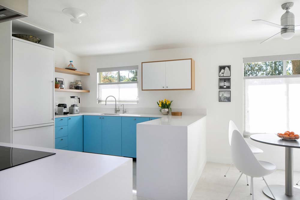 Eat-in kitchen remodel with undermount sink, light blue kitchen cabinets, quartz countertops, white backsplash and paneled appliances