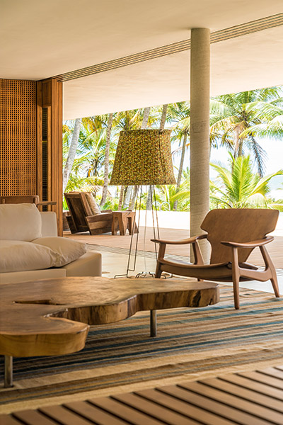 Beautiful Brazilian living room with creative table in a striking modern house by Studio MK27