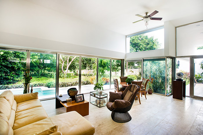 Large living room overlooking lush garden in award-winning house in Yucatan, Mexico