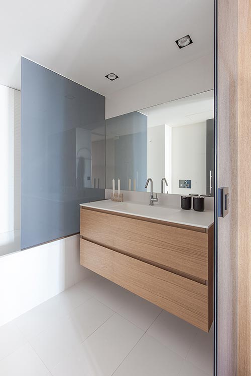 Suspended oak sink in a small bathroom - renovated one-bedroom home in Barcelona, Spain by YLAB Arquitectos