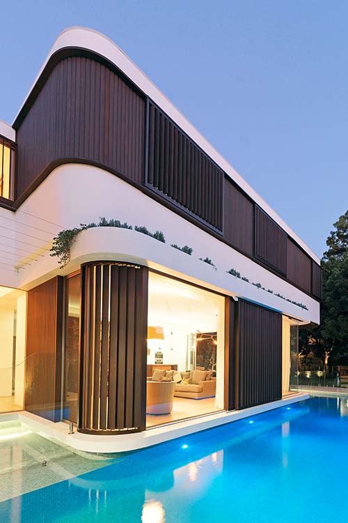 Two-storey addition in Australia surrounded by a swimming pool