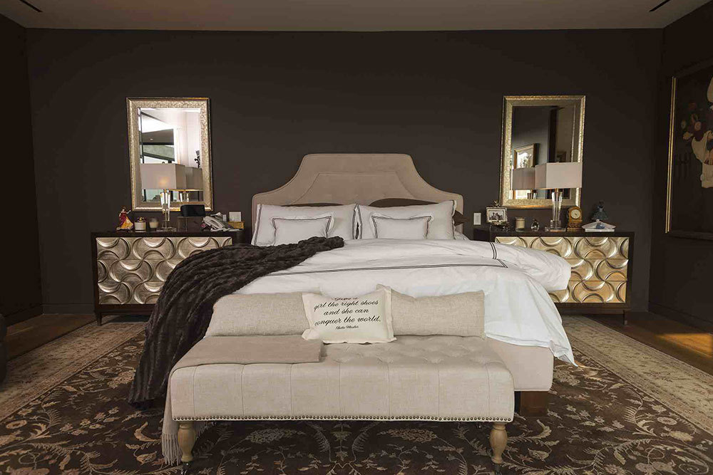 Luxurious bedroom design with dark paint wall and expensive furniture