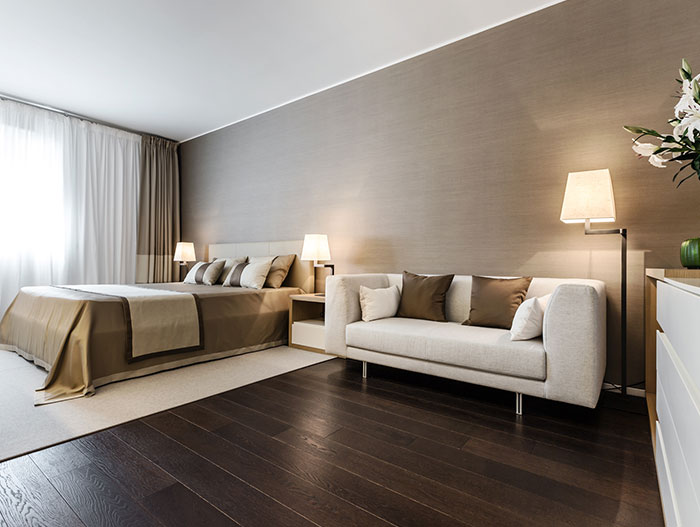 Luxurious master bedroom with color palette that resembles the sand and stone of the French Riviera where the apartment is located