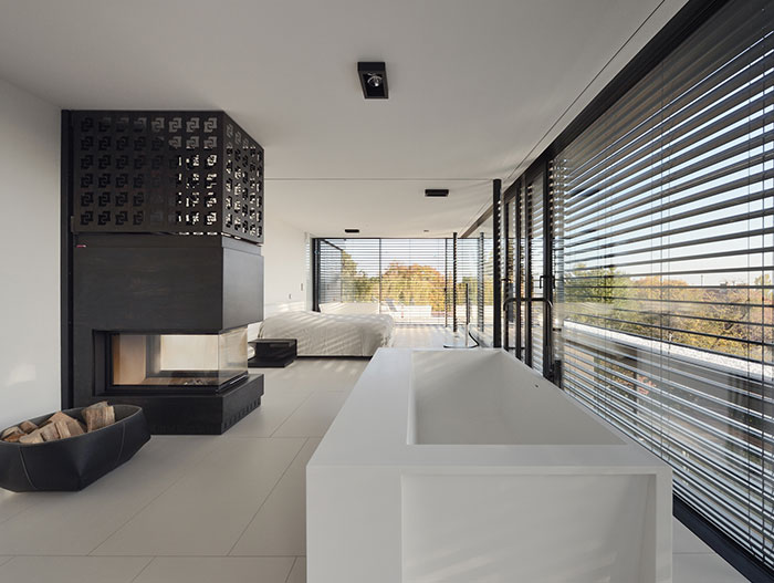 Stylish, white master bedroom design idea in a luxurious villa located in Vienna, Austria