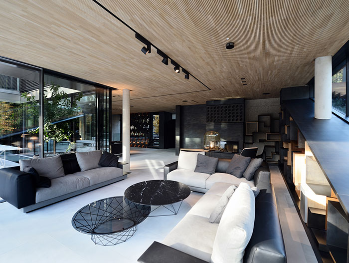 Stylish living room design with beautiful glass coffee tables and modern, white sofa in a luxurious villa located in Vienna, Austria