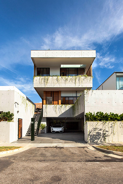 Entrance to luxury house in East Singapore by Aamer Architects - luxury car parked outside