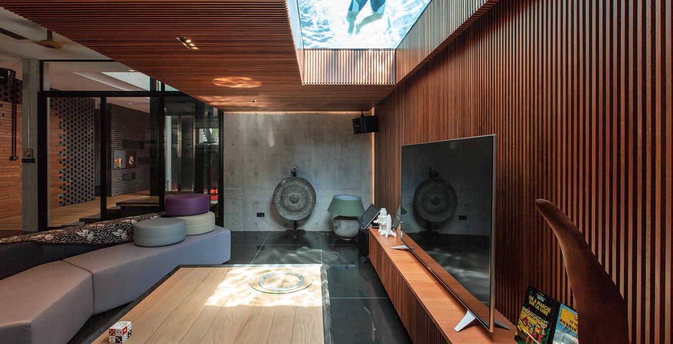 Luxury living room overlooks swimming pool of East Singapore house by Aamer Architects