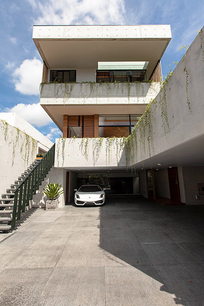 Luxury house with luxury Lamborghini parked outside - East Singapore designed by Aamer Architects