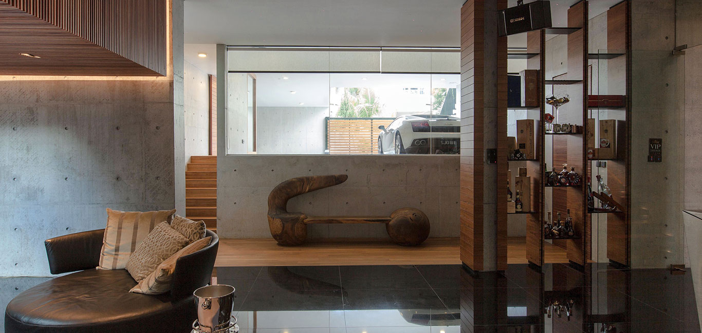 Luxury living room overlooks garage with Lamborghini in luxury house East Singapore by Aamer Architects