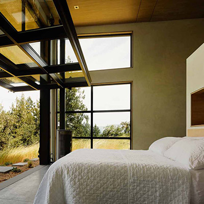 Modern California home with massive glass walls which allows master bedroom to open up to the spectacular surroundings