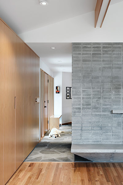 Modern corridor and fireplace in remodeled 1967 house near Seattle