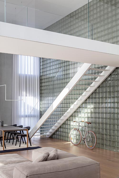 Bright duplex in Israel features a glass block wall