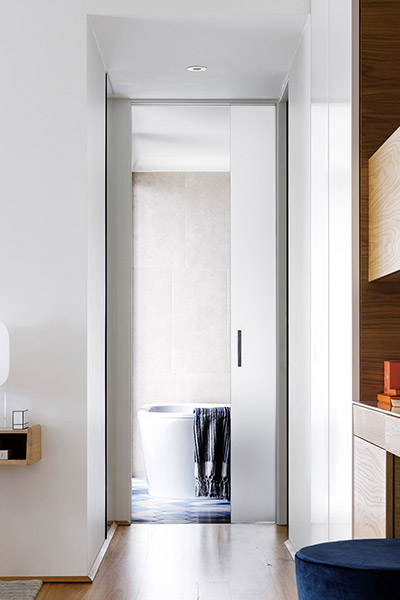 Beautiful modern hallway leading to bathroom inside contemporary Australian home