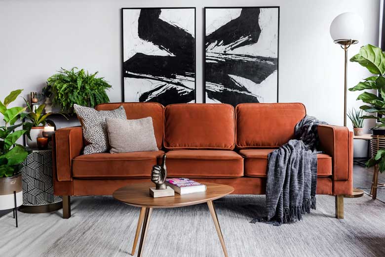 Modern rust velvet sofa with gold legs