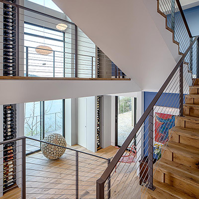 Modern staircase leads to eclectic interior in cliff dwelling near lake Austin, Texas, USA