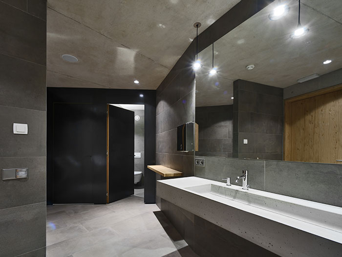 Modern bathroom design idea in Oberholz Mountain Hut by Peter Pichler Architects, a wooden restaurant that is a landmark in the Italian Alps