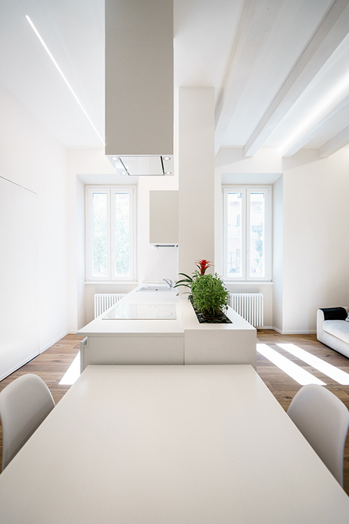 All-white minimalist apartment with open-space kitchen, dining and living area in Rome, Italy by Brain Factory - Architecture & Design